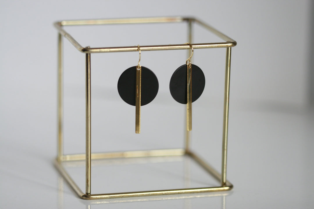 These geometric black and brass gold statement earrings make a big statement, yet are still so easy to wear. Unsurprisingly, gold symbolises wealth and prosperity. Black signifies powerfulness and sophistication. Earring hoop is gold plated. Designed and handcrafted in Ireland.