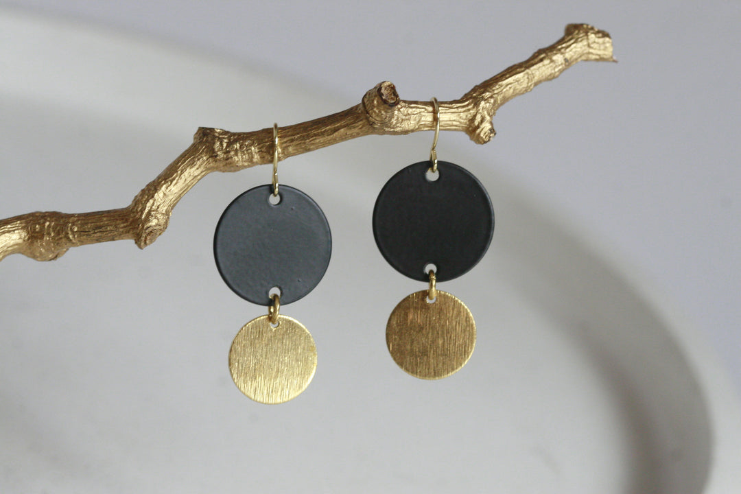 These geometric black and brass gold disc earrings make a big statement, yet are still so easy to wear. Unsurprisingly, gold symbolises wealth and prosperity. Black signifies powerfulness and sophistication. Earring hoop is gold plated. Designed and handcrafted in Ireland.